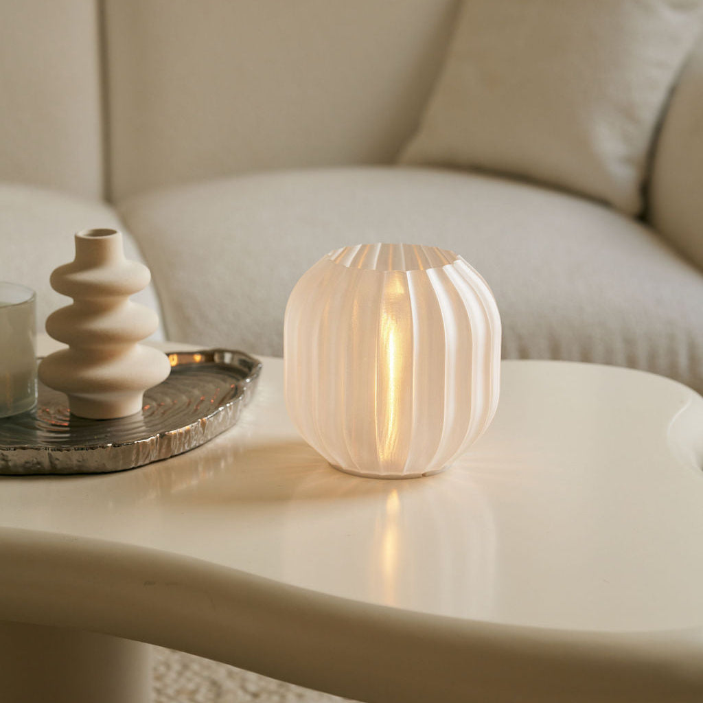 Decorative lamp on a table with a blurred sofa in the background